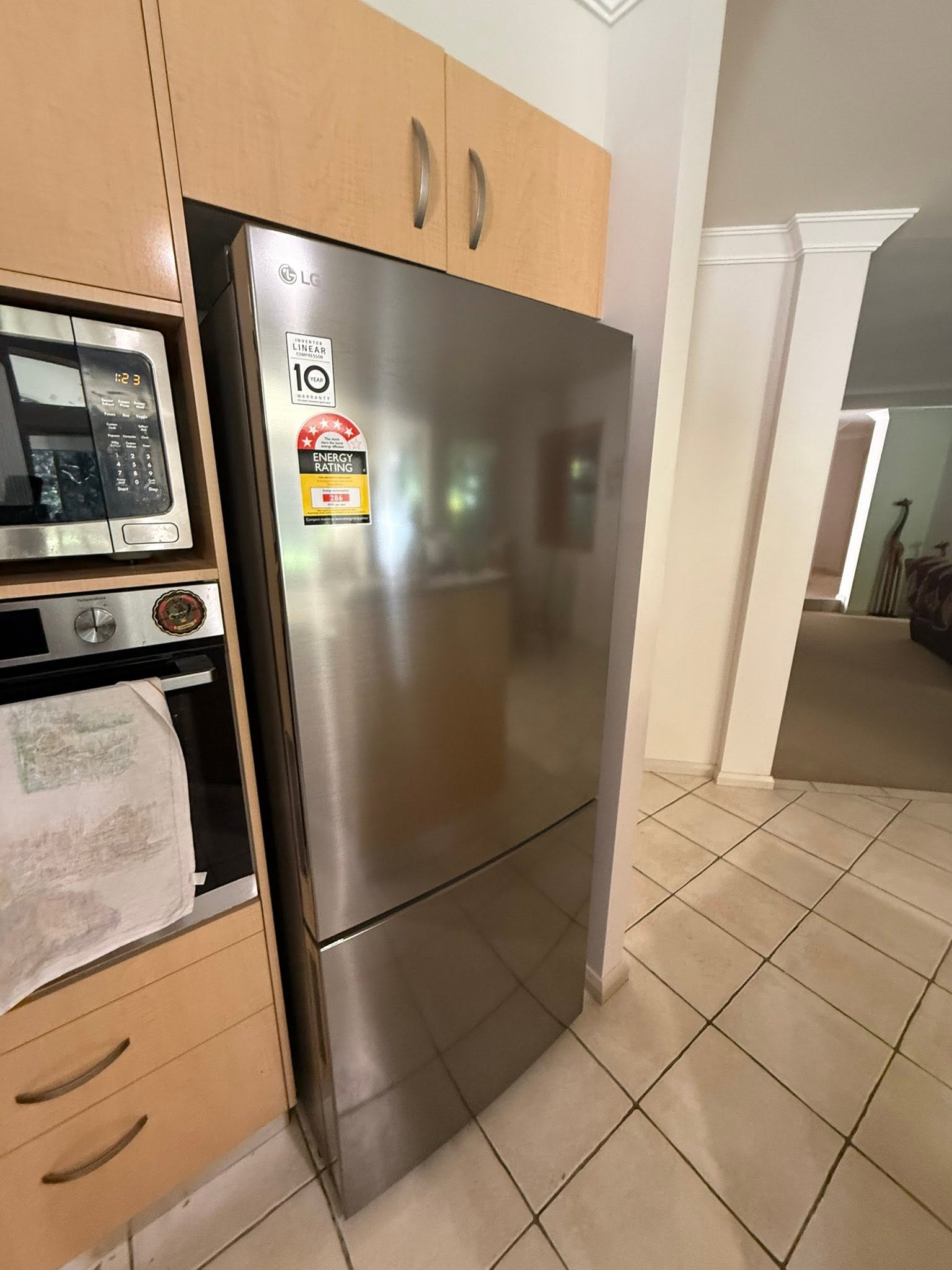 LG stainless steel refrigerator installed into kitchen cabinetry